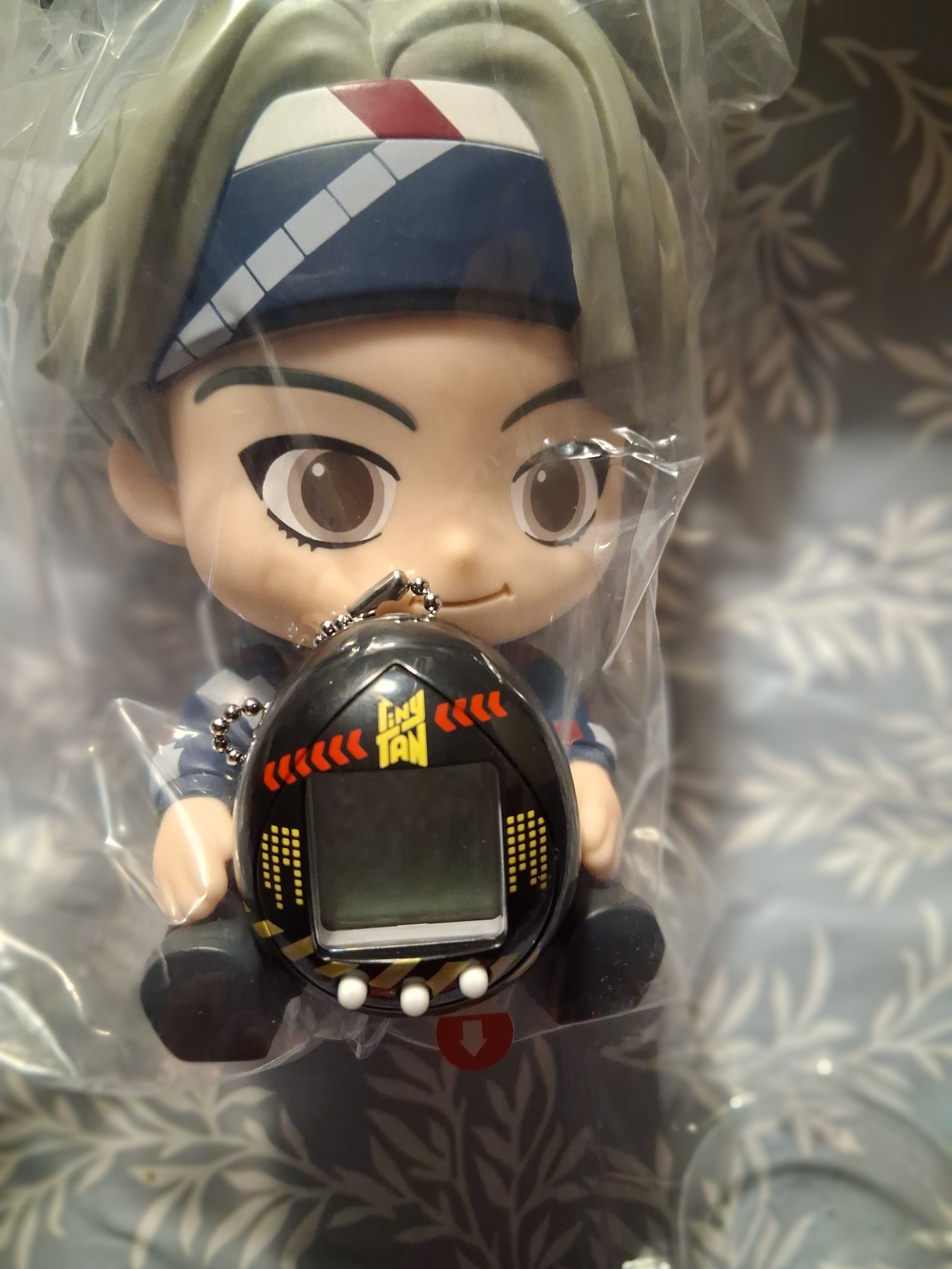 V statue with tiny Tamagotchi